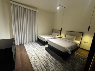 a hotel room with two beds and a television at Private Somabay Villa with Pool in Hurghada