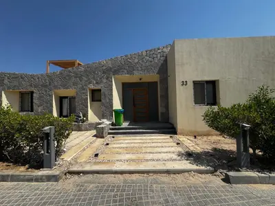 a building with a red door and a stairway at Private Somabay Villa with Pool in Hurghada