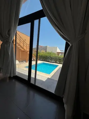 a view of a swimming pool through a window at Private Somabay Villa with Pool in Hurghada