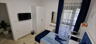 a small room with a bed and a shower at Hurgada Princess resort on Mamsha with private beach&pools in Hurghada