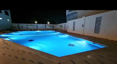 a large swimming pool at night with blue illumination at Hurgada Princess resort on Mamsha with private beach&pools in Hurghada