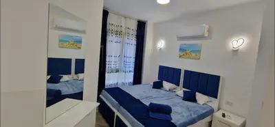 a bedroom with two beds and a mirror at Hurgada Princess resort on Mamsha with private beach&pools in Hurghada