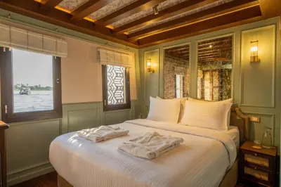 a bedroom with a large bed with towels on it at HMC Musk Dahabyia in Luxor