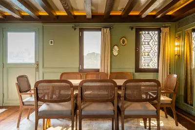 a dining room with a table and chairs at HMC Musk Dahabyia in Luxor
