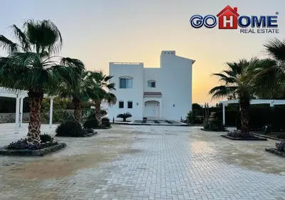 a large white building with palm trees in front of it at Spacious Villa 4 Broom Private Pool V35 at White villa in Hurghada