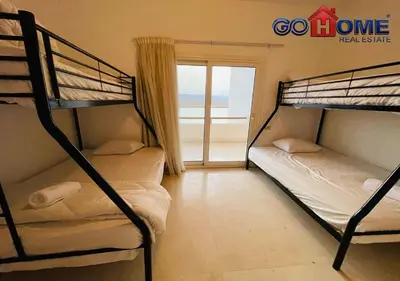 two bunk beds in a room with a balcony at Spacious Villa 4 Broom Private Pool V35 at White villa in Hurghada