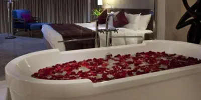 a tray filled with red roses in a room at Royal Jade wellness luxurios Dahabiya Nile Cruise Every Monday from Luxor to Aswan 4 nights and Every Friday from Aswan to Luxor 3 nights in Luxor