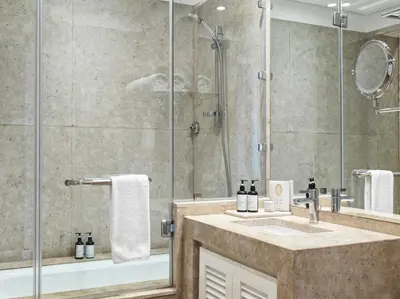 a bathroom with a shower and a sink at Ancient Sands Golf Resort and Residences in Hurghada