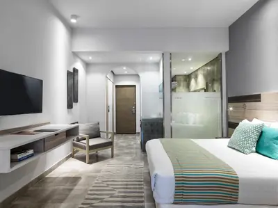 a hotel room with a bed and a television at Ancient Sands Golf Resort and Residences in Hurghada