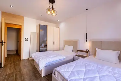 a bedroom with two beds and a chandelier at Private Villa AL Mamsha With Private Pool in Hurghada