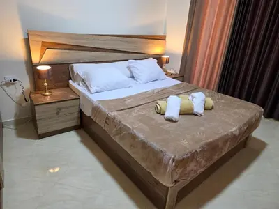 a bedroom with a bed with two towels on it at Do wynajęcia apartament w Hurghadzie w resorcie Aqua Tropical in Hurghada