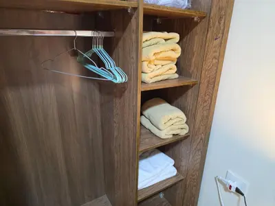 a wooden towel rack with towels in a bathroom at Do wynajęcia apartament w Hurghadzie w resorcie Aqua Tropical in Hurghada