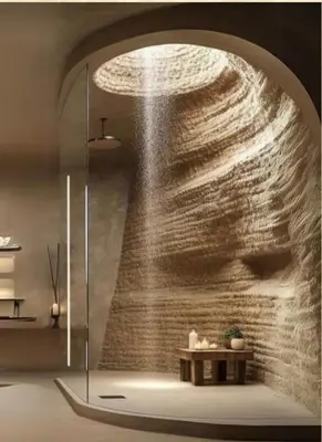 a shower in a bathroom with a stone wall at Royal Amber in Luxor