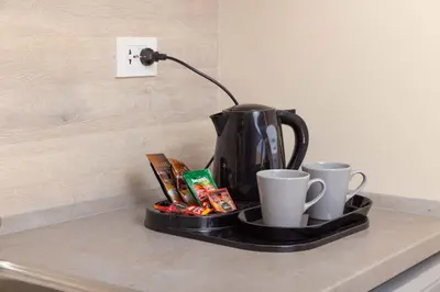 a coffee pot and cups on a tray on a counter at Hurgada El Gouna Mangroovy 1 bedroom with roof top in Hurghada