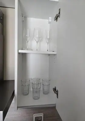 four wine glasses on a shelf in a kitchen at Hurgada El Gouna Mangroovy 1 bedroom with roof top in Hurghada