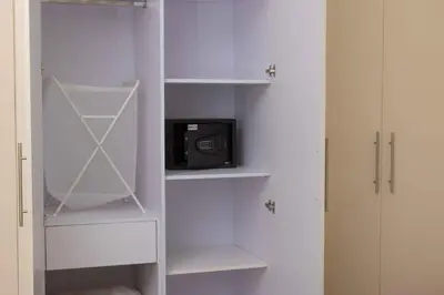 a white closet with a microwave and a tv at Hurgada El Gouna Mangroovy 1 bedroom with roof top in Hurghada
