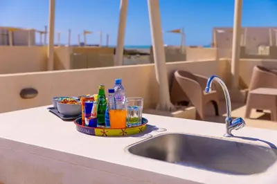 a kitchen counter with a sink and a tray of drinks at Hurgada El Gouna Mangroovy 1 bedroom with roof top in Hurghada