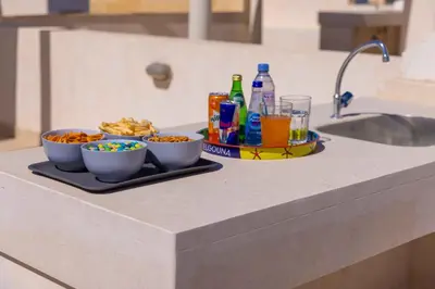 a tray with bowls of food and drinks on a counter at Hurgada El Gouna Mangroovy 1 bedroom with roof top in Hurghada
