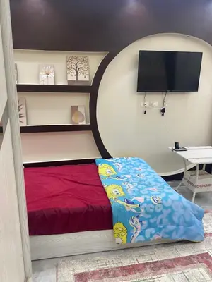 a bedroom with a bed and a flat screen tv at Al fayrouz resort in Hurghada