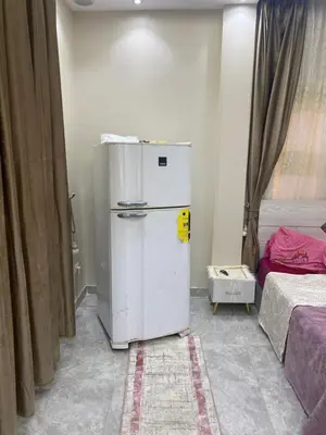 a white refrigerator in a room next to a bed at Al fayrouz resort in Hurghada