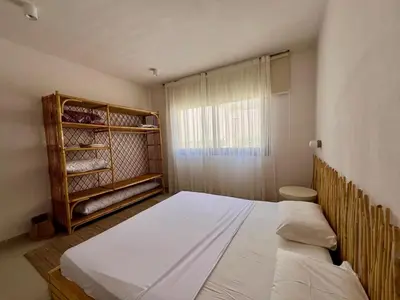 a bedroom with a large bed and a window at G-Cribs 1BR • Boho Pool Access in Hurghada