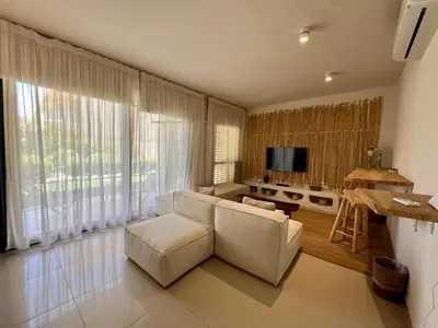 a living room with a white couch and a table at G-Cribs 1BR • Boho Pool Access in Hurghada