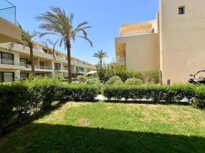 a yard in front of a building with palm trees at G-Cribs 1BR • Boho Pool Access in Hurghada