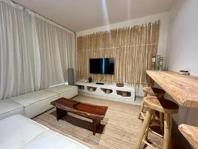 a living room with a couch and a tv at G-Cribs 1BR • Boho Pool Access in Hurghada