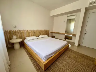 a bedroom with a large bed and a sink at G-Cribs 1BR • Boho Pool Access in Hurghada