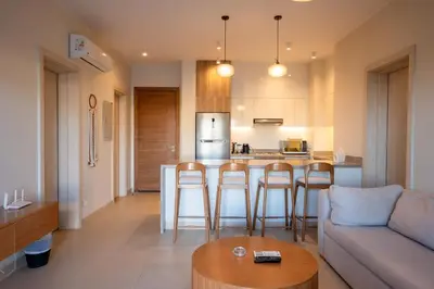 a kitchen and living room with a couch and a table at Shedwan 2BR • Exquisite Ground Floor in Hurghada