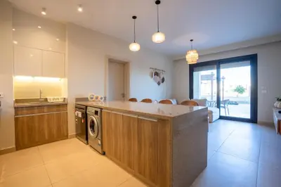 a large kitchen with a washer and dryer in it at Shedwan 2BR • Exquisite Ground Floor in Hurghada