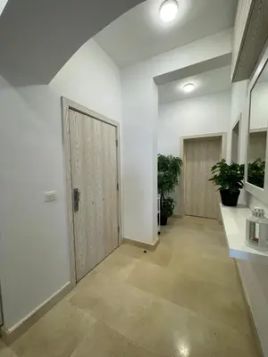 a hallway with white walls and a door at Cozy 1 bedroom Apartment in Azzurra Sahl Hasheesh in Hurghada