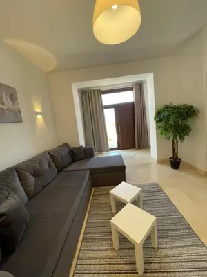 a living room with a couch and a table at Spacious sea view ,1 bedroom apartment in Azzurra Sahl Hasheesh in Hurghada