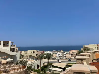 a view of a city with the ocean in the background at Spacious sea view ,1 bedroom apartment in Azzurra Sahl Hasheesh in Hurghada