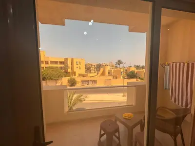a room with a view of a city from a window at Florenza Khamasin C105 in Hurghada