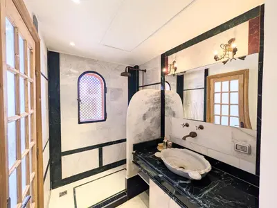 a bathroom with a sink and a mirror at Super Central Somabay 2BR Marina Apt w Free Beach in Hurghada