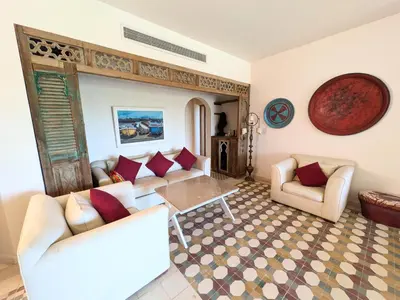 a living room with couches and a table at Super Central Somabay 2BR Marina Apt w Free Beach in Hurghada