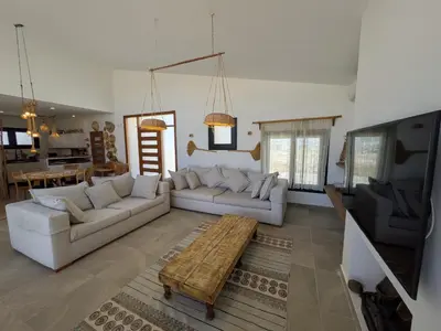 a living room with white couches and a tv at Seafront 3BR Soma Bay Villa With Exquisite Views in Hurghada