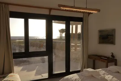 a bedroom with a large window looking out at the ocean at Seafront 3BR Soma Bay Villa With Exquisite Views in Hurghada