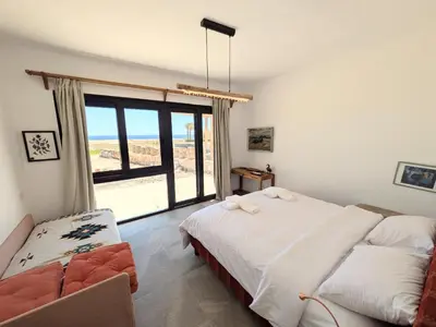 a bedroom with a bed and a large window at Seafront 3BR Soma Bay Villa With Exquisite Views in Hurghada