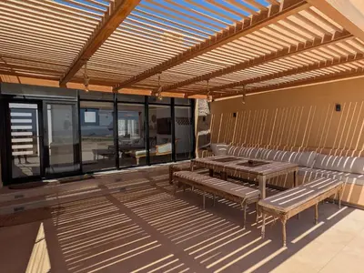 a room with benches and tables on a deck at Seafront 3BR Soma Bay Villa With Exquisite Views in Hurghada