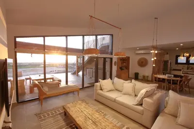 a living room with a white couch and a table at Seafront 3BR Soma Bay Villa With Exquisite Views in Hurghada