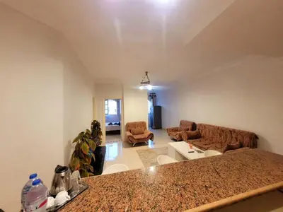 a kitchen and living room with a counter top at Alisra Hurghada Building in Hurghada