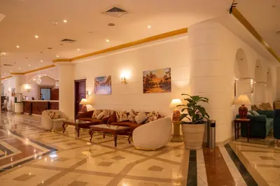 a lobby with couches and chairs in a building at Roma Hotel in Hurghada