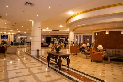 a lobby with a table in the middle of a building at Roma Hotel in Hurghada