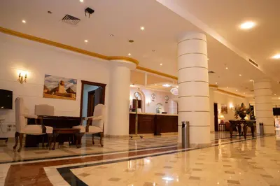 a living room with columns and a dining room at Roma Hotel in Hurghada