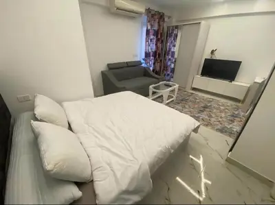 a living room with a white bed and a couch at Princess Resort in Hurghada