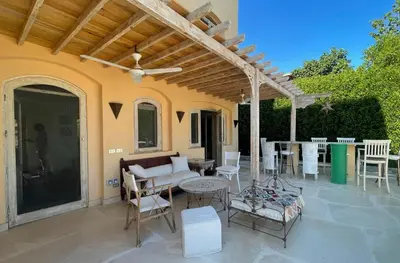 a patio with a couch and chairs and a table at El Gouna Villa Upper-Nubia, Sleeps 4-6 Persons in Hurghada