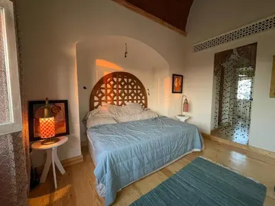 a bedroom with a large bed and a table at El Gouna Villa Upper-Nubia, Sleeps 4-6 Persons in Hurghada