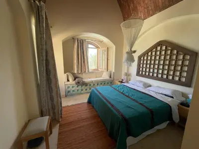 a bedroom with a large bed and a window at El Gouna Villa Upper-Nubia, Sleeps 4-6 Persons in Hurghada